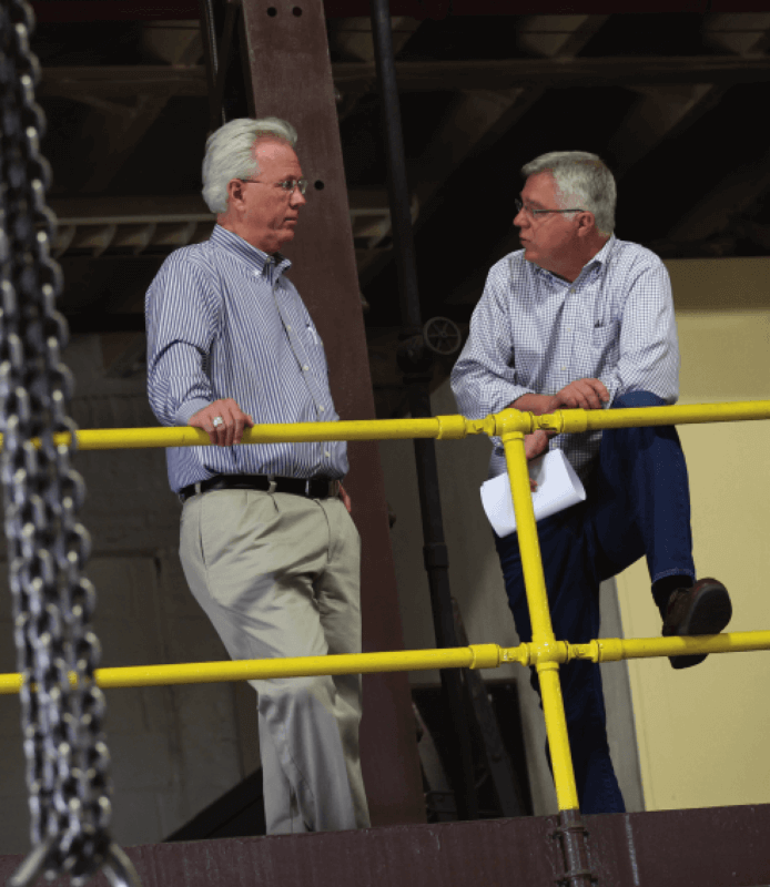 Tom Garrity talking with owner of Bradley Pulverizer