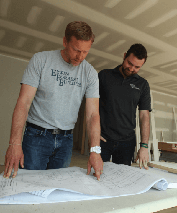 owner of erwin builders looking at blueprints